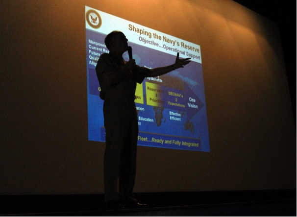 a man giving presentation with slides projected on screen